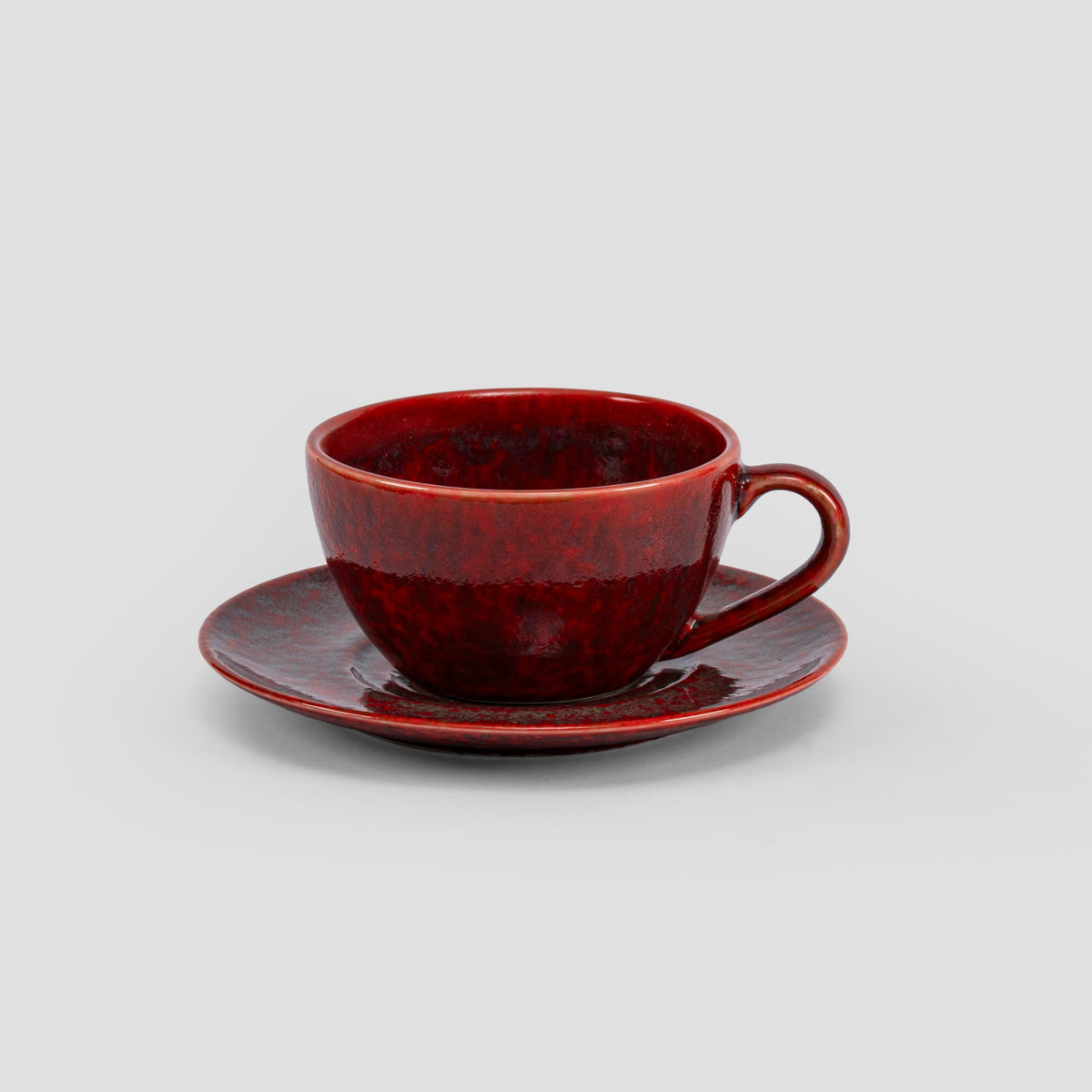 Homura red porcelain cup and matched saucer